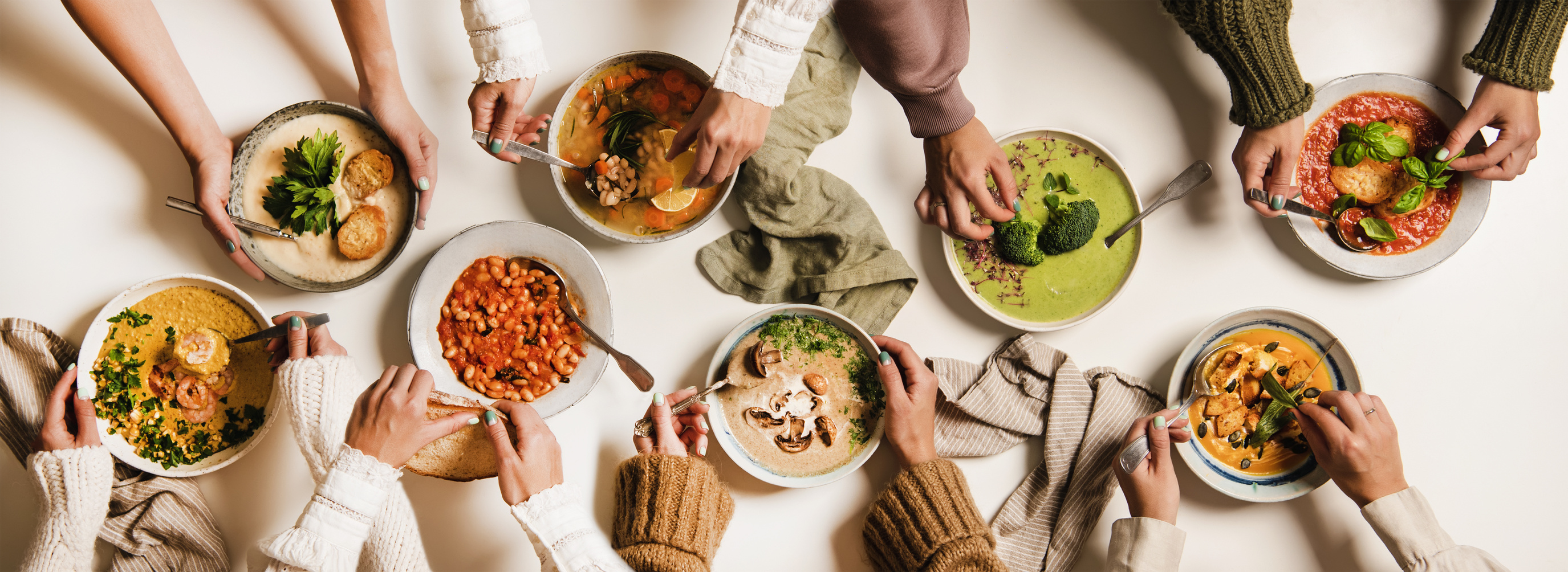 People eating Autumn Winter creamy vegan soups over white table